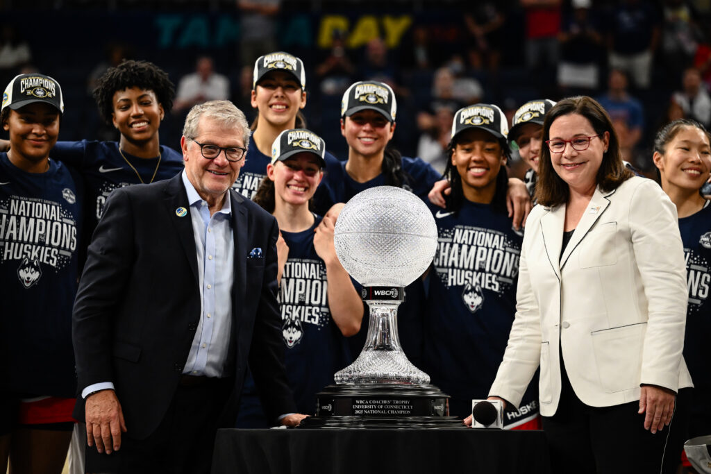 UConn basketball head coach Geno Auriemma poses with the WBCA award after winning the 2025 NCAA championship.