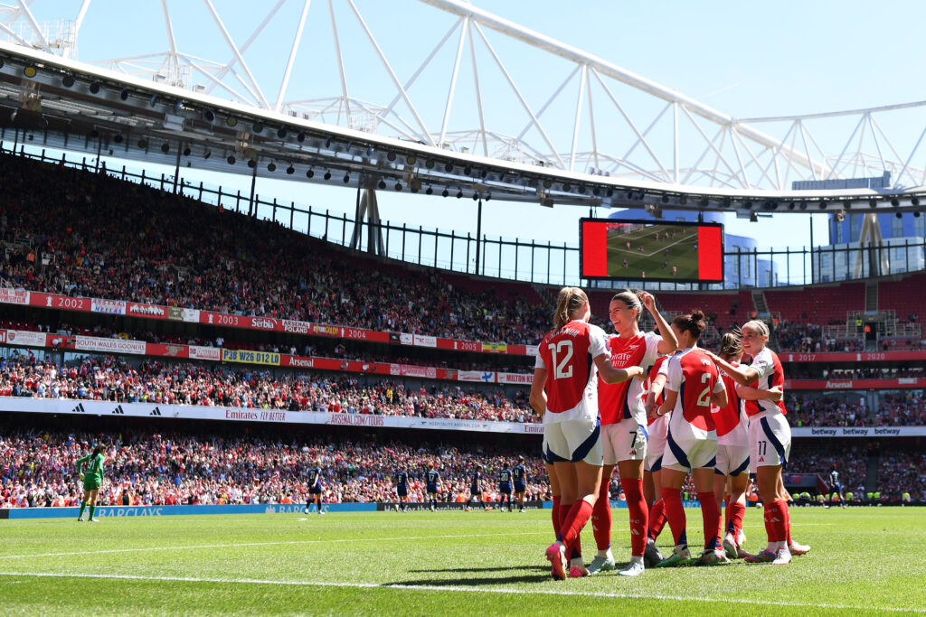 Frida Maanum celebrates with Arsenal teammate Steph Catley during a 2025 WSL match.