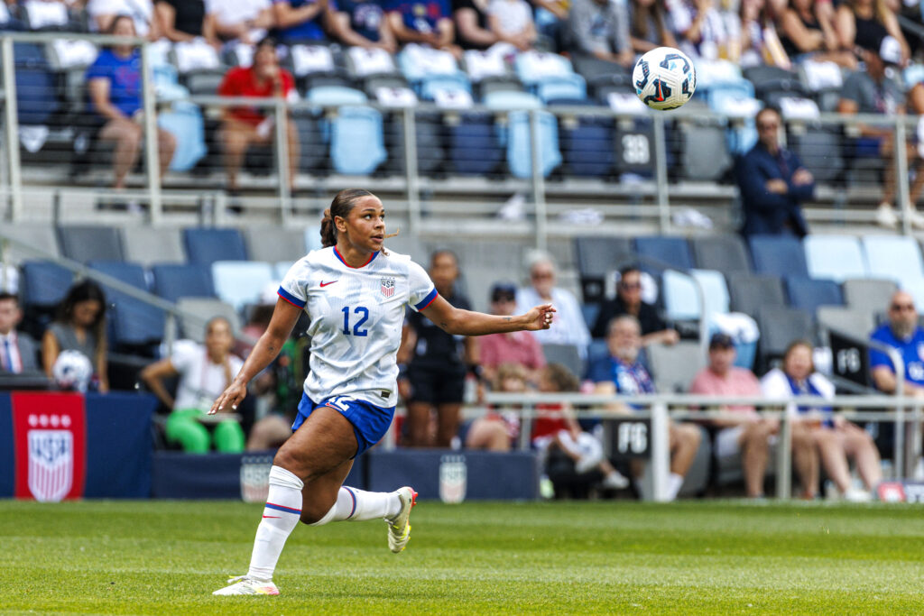 USWNT winger Michelle Cooper eyes an incoming ball during a 2025 friendly against China PR.