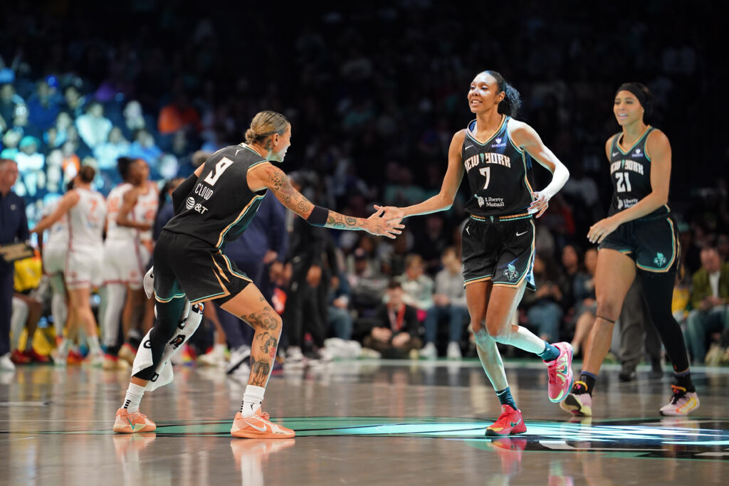 New York Liberty guard Natasha Cloud high-fives teammate Rebekah Gardner during a 2025 WNBA Commissioner's Cup game.