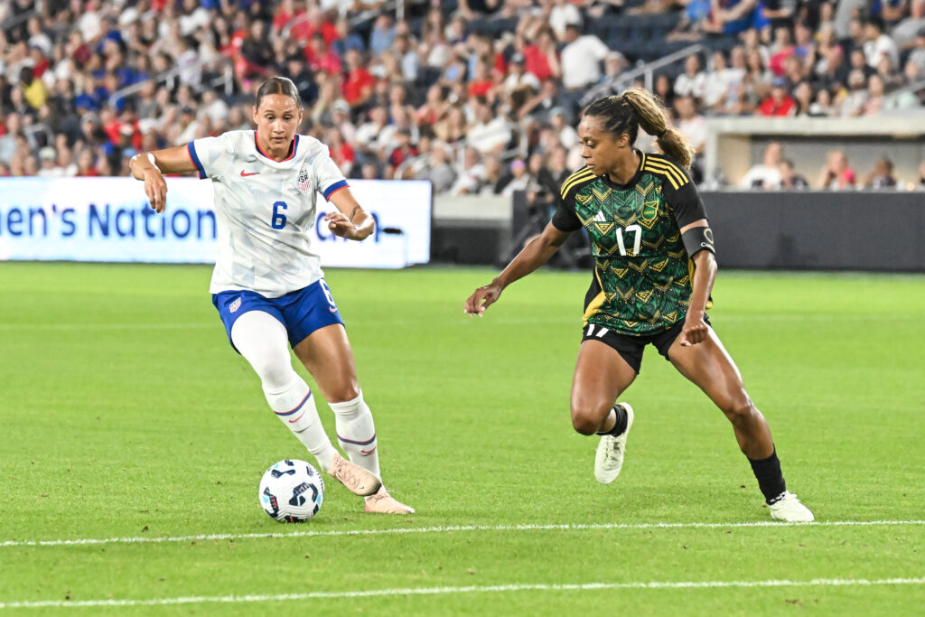 USWNT forward Lynn Biyendolo dribbles away from Jamaica defender Allyson Swaby during a 2025 friendly.