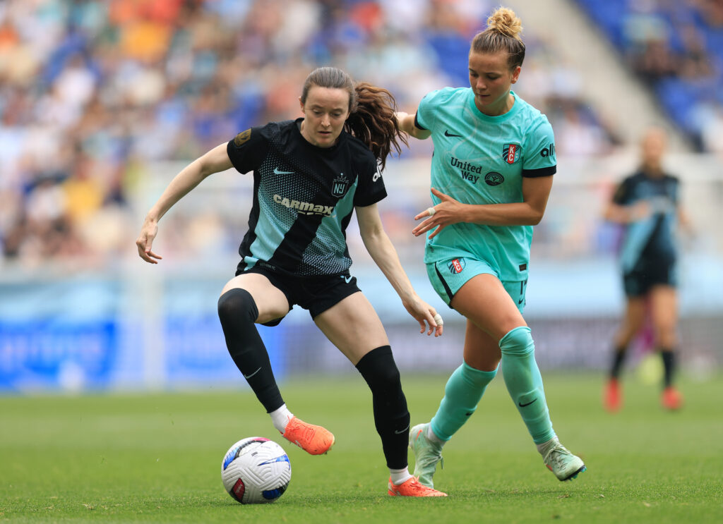 Gotham FC's Rose Lavelle dribbles the ball away from Kansas City's Claire Hutton in a 2025 NWSL match.