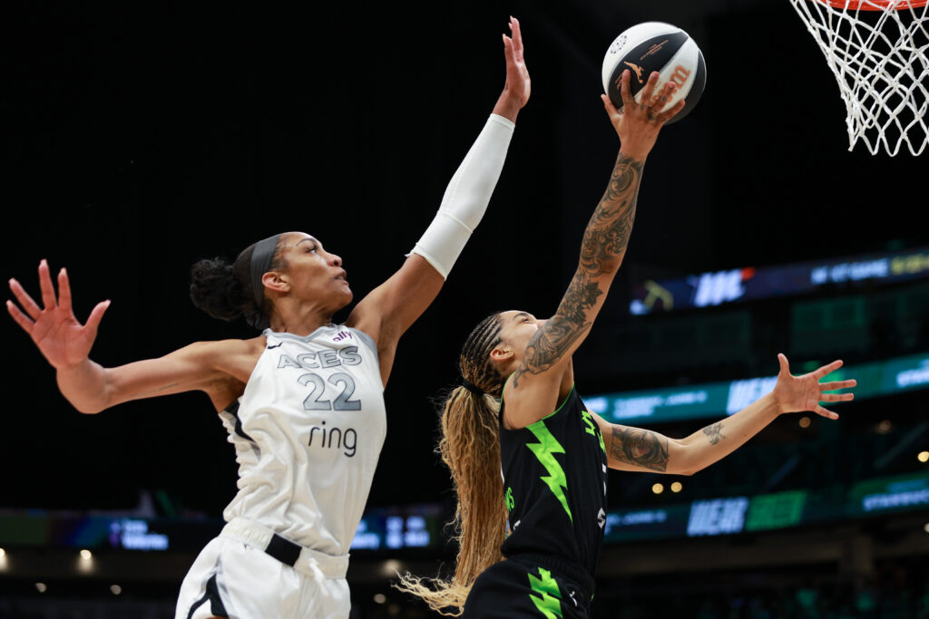 Las Vegas's A'ja Wilson tries to defend a lay-up from Seattle's Gabby Williams during a 2025 WNBA game.