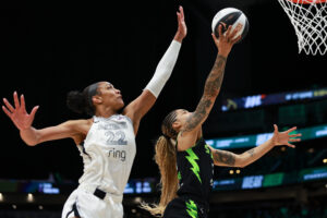 Las Vegas's A'ja Wilson tries to defend a lay-up from Seattle's Gabby Williams during a 2025 WNBA game.