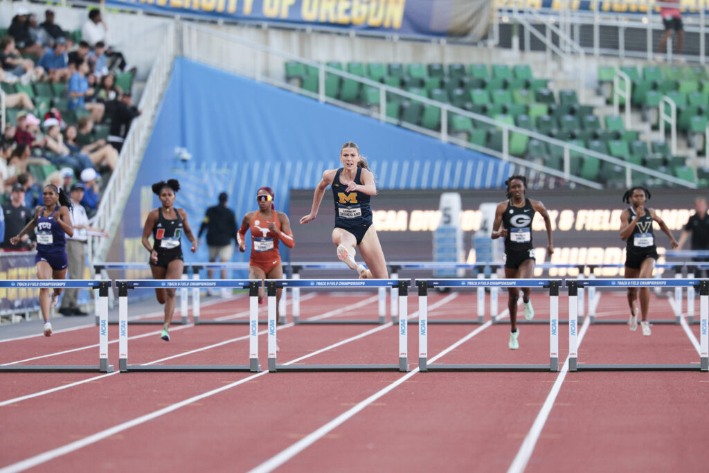 Michigan senior Savannah Sutherland leaps over a hurdle in the 400-meter hurdles final at the 2025 NCAA Division I Outdoor Track and Field Championships.