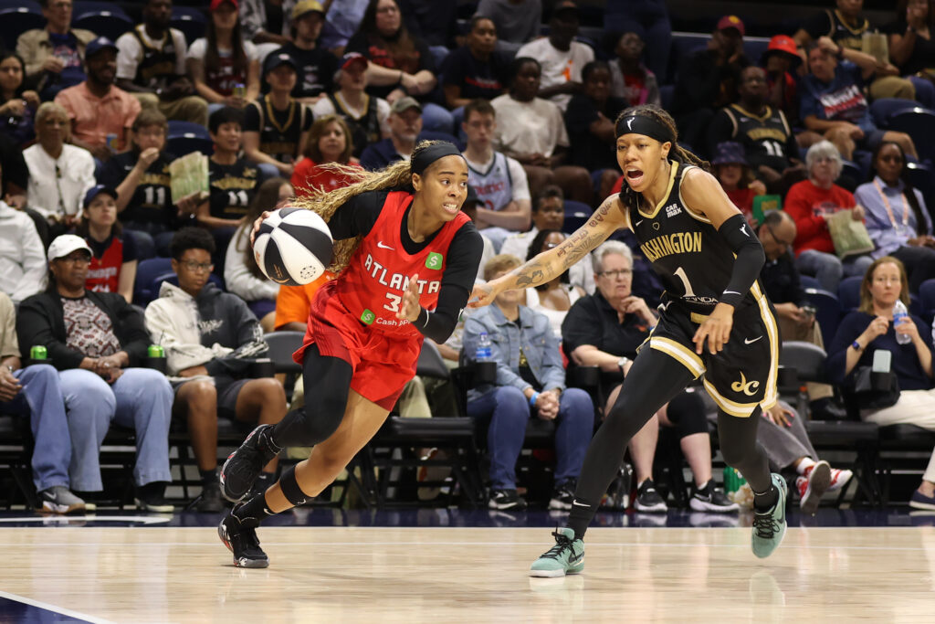 Washington's Sug Sutton tries to defend as the Atlanta Dream's Jordin Canada drives to the basket during a 2025 WNBA game.