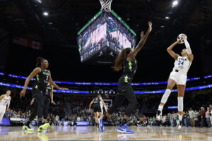 Seattle Storm forward Ezi Magbegor tries to defend a jump-shot from Minnesota Lynx forward Napheesa Collier during a 2025 WNBA Commissioner's Cup game.
