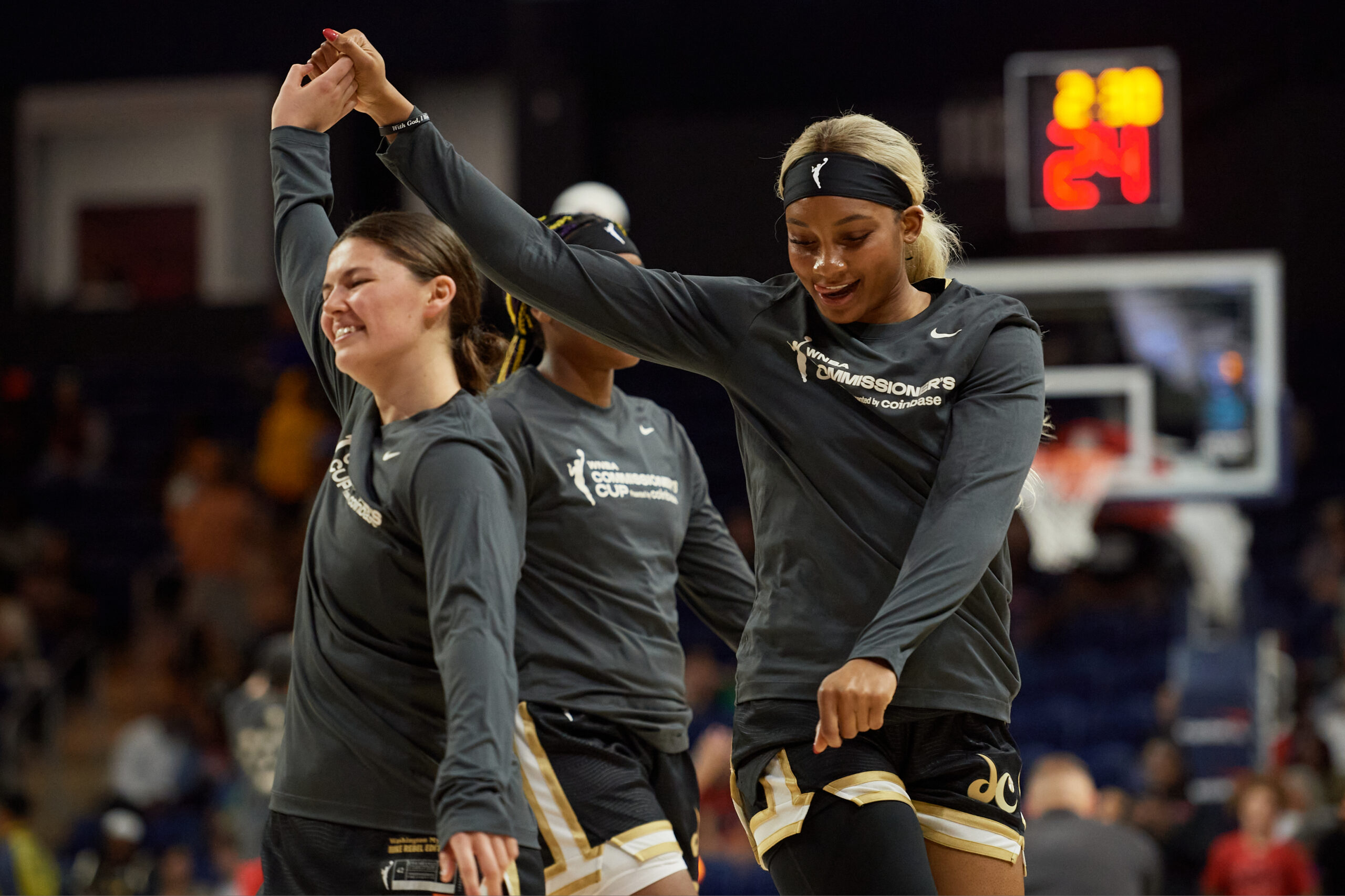 Jade Melbourne #5 and rookie Kiki Iriafen #44 of the Washington Mystics dance during warmups before the game against the Atlanta Dream at Carefirst Arena on June 15, 2025 in Washington, DC. 