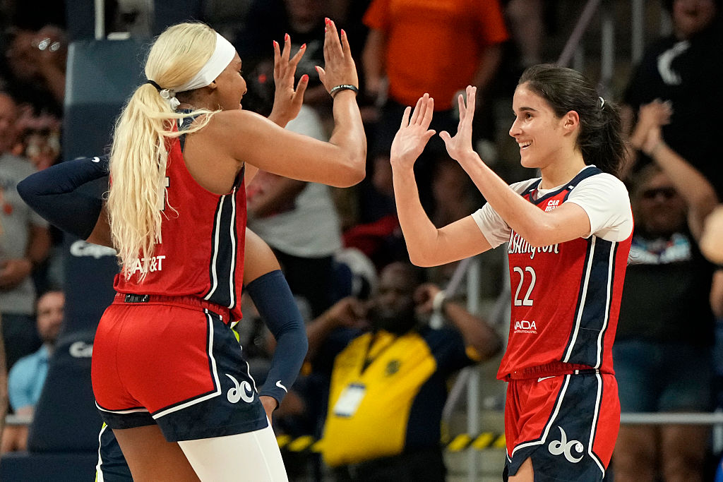 Rookies Sonia Citron #22 of the Washington Mystics celebrates with Kiki Iriafen #44 after scoring the game-winning three-point shot in overtime against the Dallas Wings at Carefirst Arena on June 22, 2025 in Washington, DC.