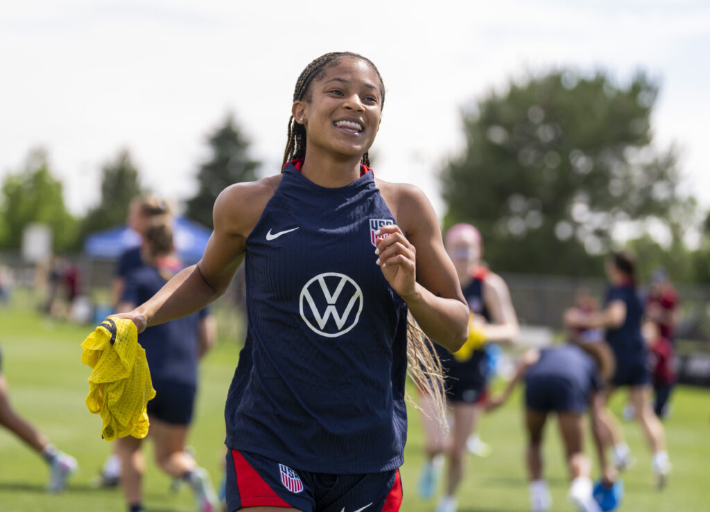 USWNT midfielder Croix Bethune smiles during a training session.