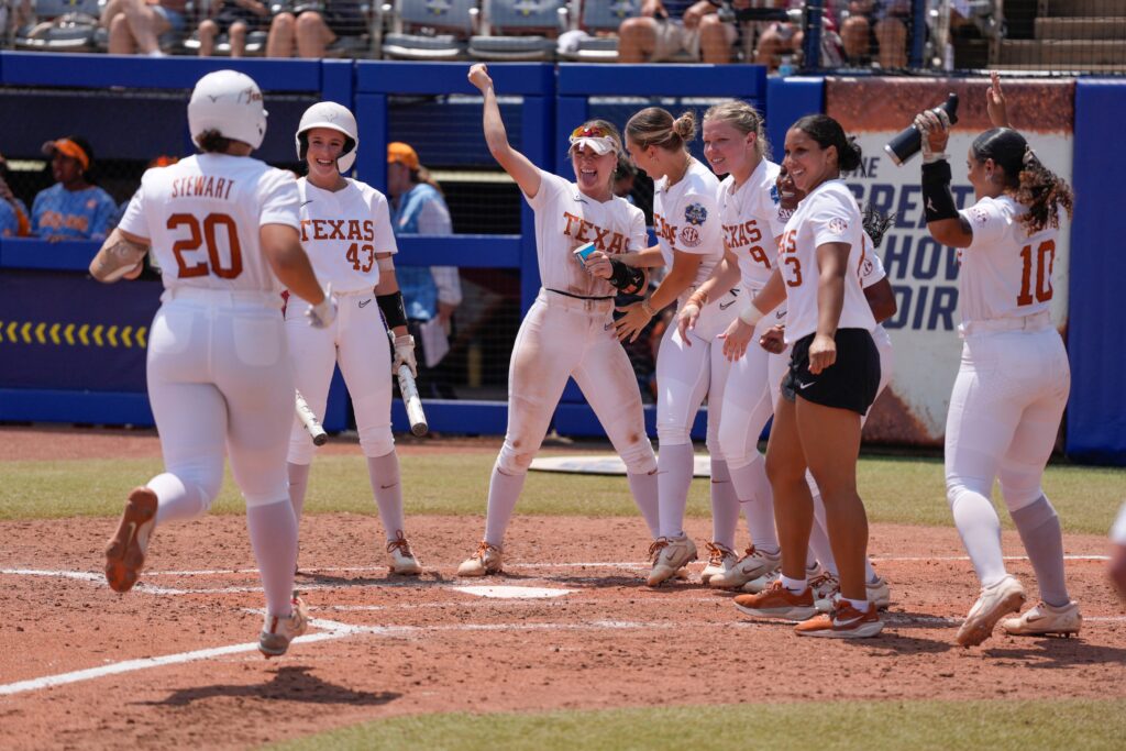 Texas softball players celebrate sophomore left fielder Katie Stewart's fourth-inning home run against Tennessee in the 2025 WCWS semifinals.