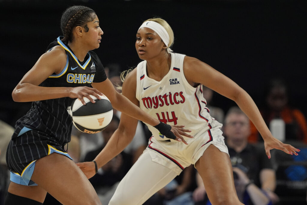 Washington Mystics rookie Kiki Iriafen defends Chicago Sky forward Angel Reese during a 2025 WNBA game.