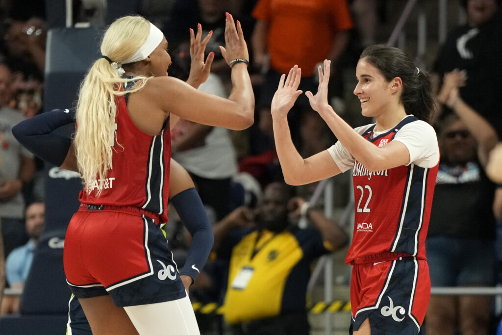 Washington Mystics rookies Kiki Iriafen and Sonia Citron high-five to celebrate a 2025 WNBA victory.