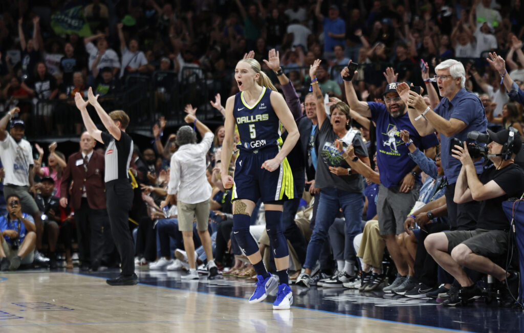 Dallas Wings rookie Paige Bueckers celebrates a play during a 2025 WNBA game against the Indiana Fever.