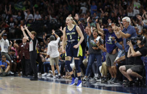 Dallas Wings rookie Paige Bueckers celebrates a play during a 2025 WNBA game against the Indiana Fever.
