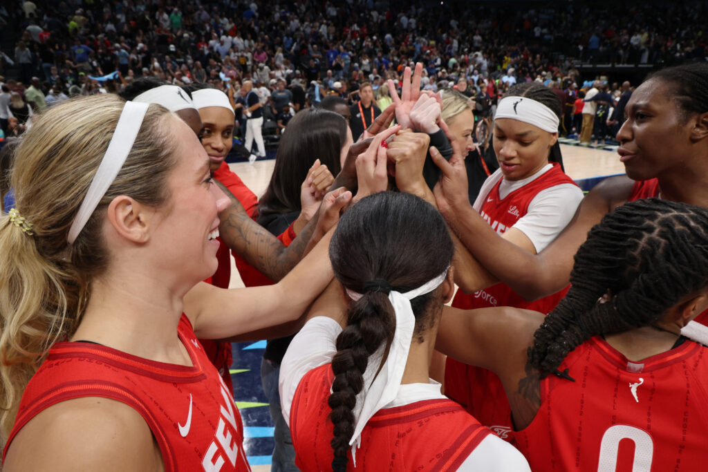 The Indiana Fever huddle during a 2025 WNBA game.
