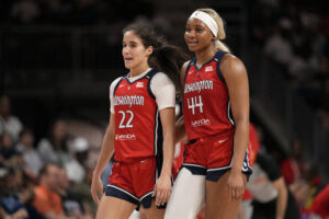 Washington Mystics rookie All-Stars Sonia Citron and Kiki Iriafen chat during a 2025 WNBA game.
