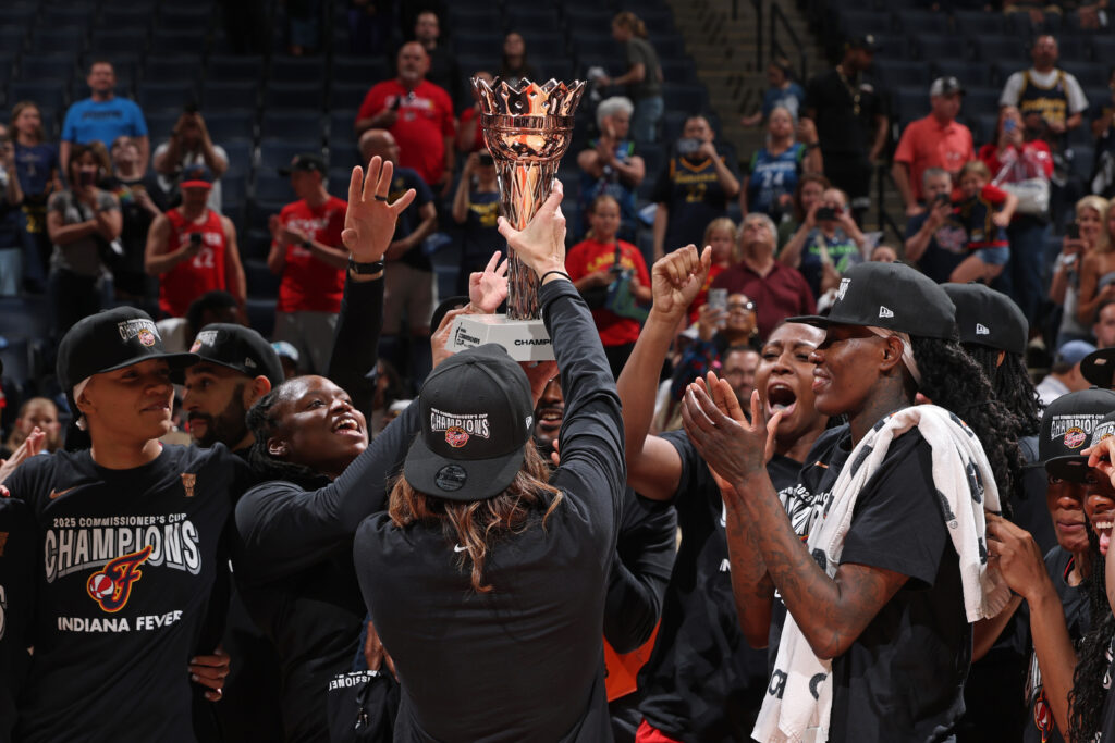 The Indiana Fever celebrate and lift the 2025 WNBA Commissioner's Cup trophy.