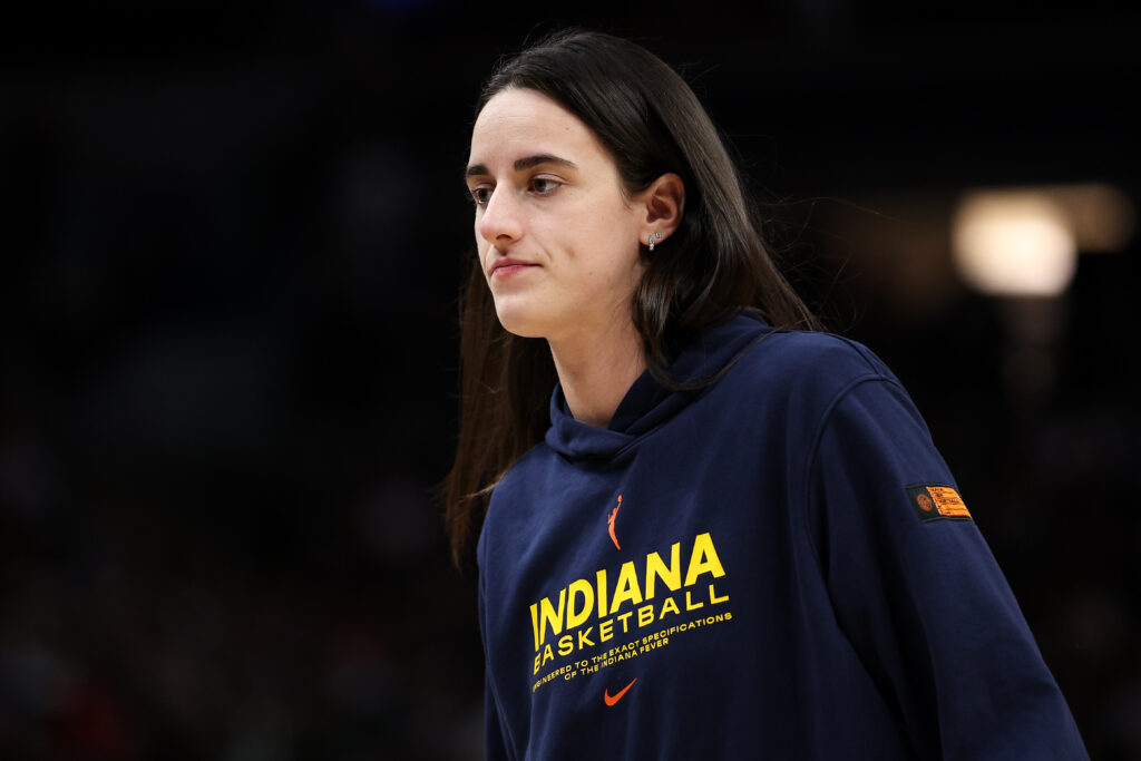 Injured Indiana Fever guard Caitlin Clark watches the 2025 WNBA Commissioner's Cup final from the bench.