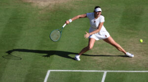 US tennis star Amanda Anisimova eyes the ball during her 2025 Wimbledon quarterfinal.