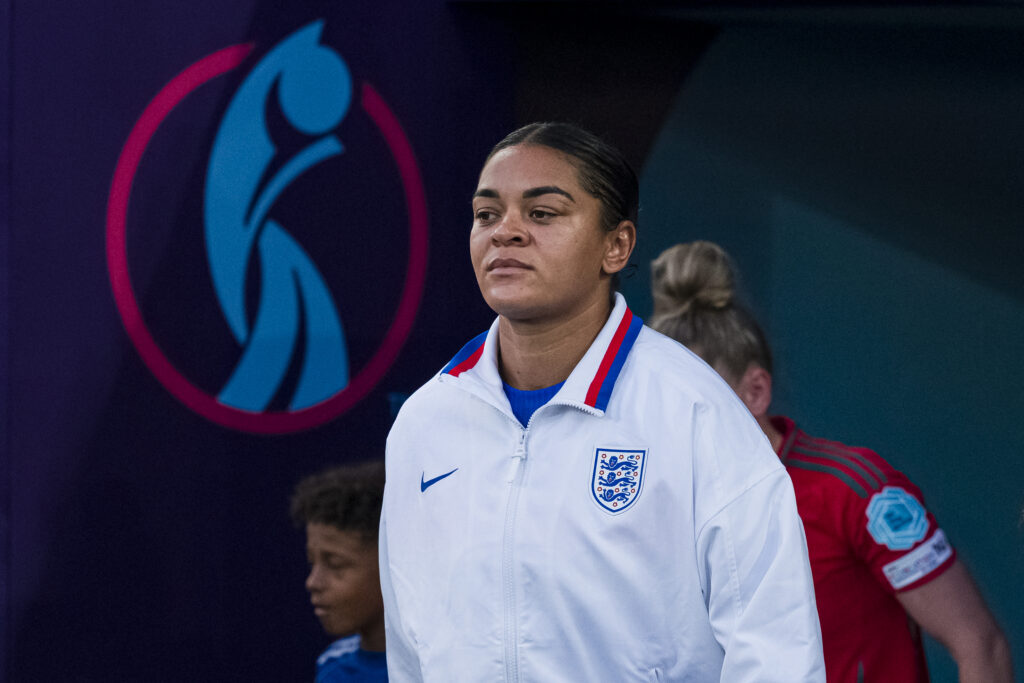 England defender Jess Carter enters the pitch for a 2025 Euro match.