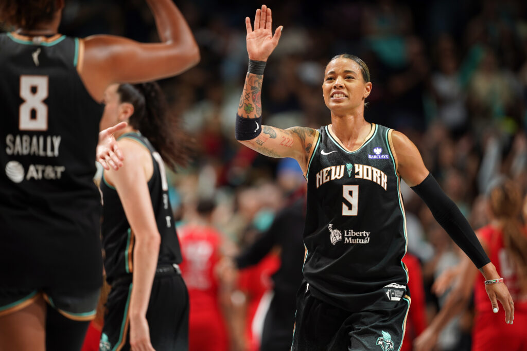 New York Liberty star Natasha Cloud looks to high-five teammate Nyara Sabally during a 2025 WNBA game.