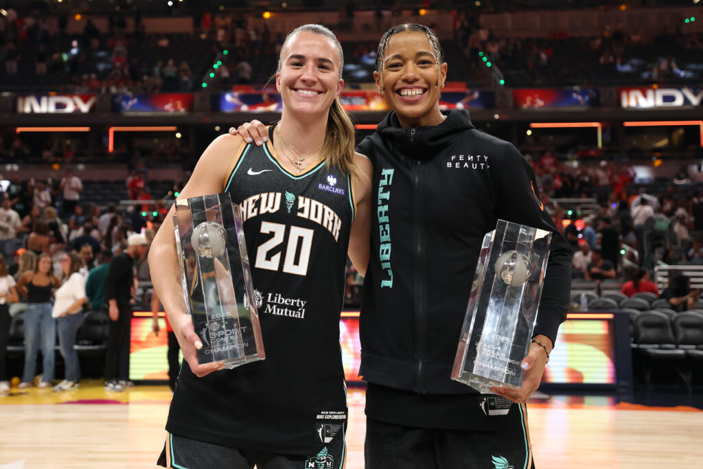 New York Liberty teammates Sabrina Ionescu and Natasha Cloud pose with their respective 2025 WNBA 3-Point Contest and Skills Challenge trophies