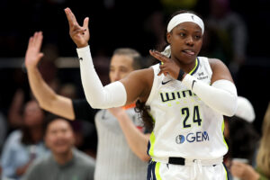 Dallas Wings star Arike Ogunbowale celebrates her three-pointer during a 2025 WNBA game.