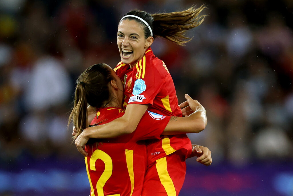 Aitana Bonmatí celebrates Spain's 2025 Euro semifinal victory with teammate Patricia Guijarro.