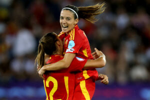Aitana Bonmatí celebrates Spain's 2025 Euro semifinal victory with teammate Patricia Guijarro.