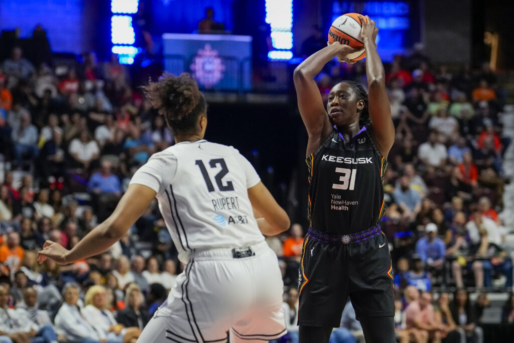 Connecticut Sun star center Tina Charles shoots over Golden State Valkyries center Iliana Rupert during a 2025 WNBA game.