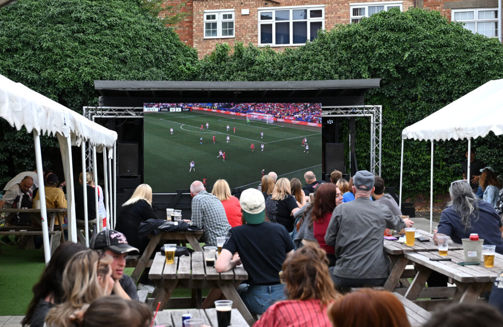 Fans watch the 2025 Euro final in the back garden of a pub in England.