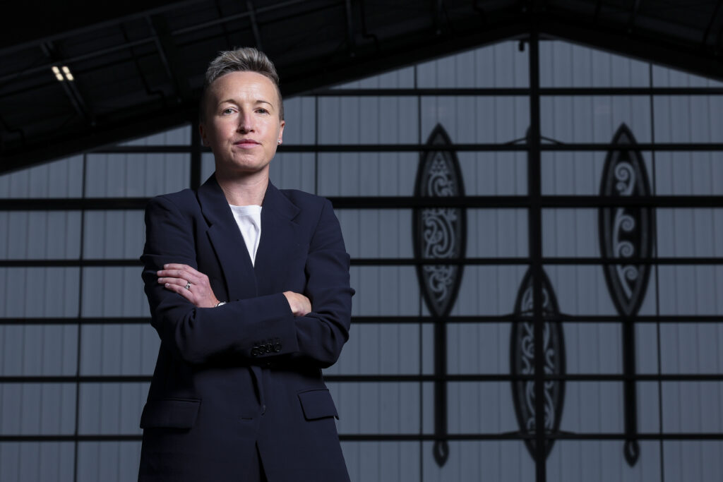 Bev Priestman poses at a 2025 announcement that she will coach New Zealand club Wellington Phoenix.