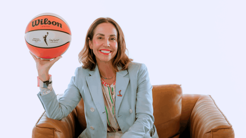 New president of business operations for Cleveland's upcoming WNBA expansion team Allison Howard poses holding a basketball.