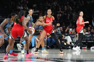 Atlanta Dream forward Naz Hillmon looks to intercept a pass to Las Vegas Aces center A'ja Wilson during a 2025 WNBA game.