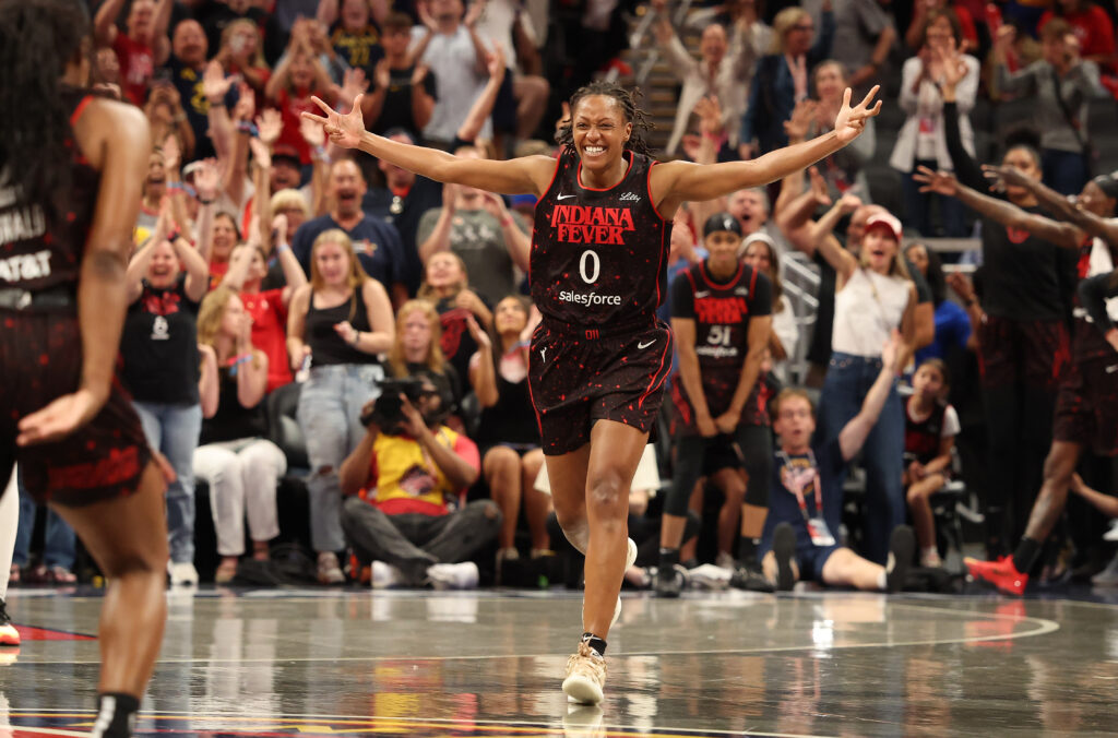 Indiana Fever guard Kelsey Mitchell celebrates a three-point shot during a 2025 WNBA game.