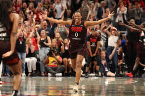 Indiana Fever guard Kelsey Mitchell celebrates a three-point shot during a 2025 WNBA game.