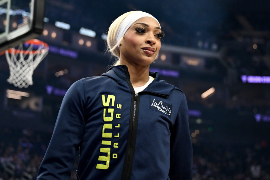The Dallas Wings' DiJonai Carrington looks on before a 2025 WNBA game.
