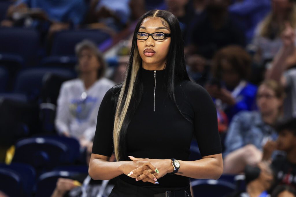 Injured Chicago Sky star Angel Reese watches from the sideline during a 2025 WNBA game.