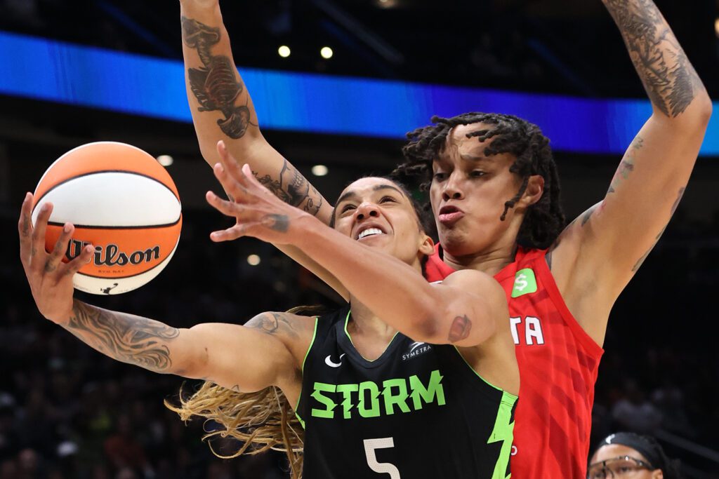 Atlanta Dream center Brittney Griner defends as Seattle Storm forward Gabby Williams drives to the basket during a 2025 WNBA game.