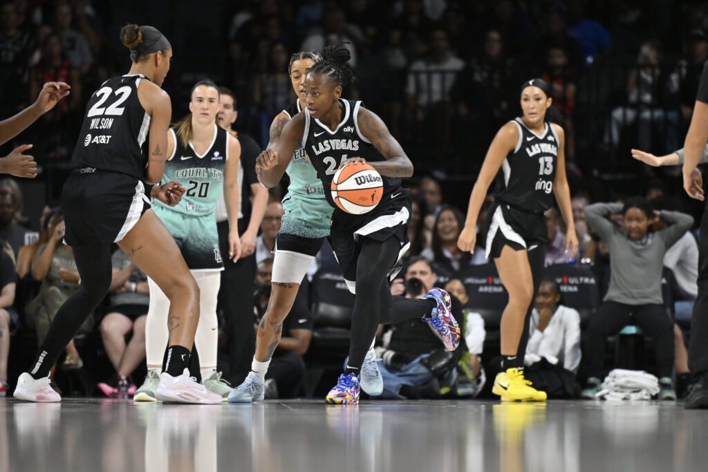 Las Vegas Aces guard Jewell Loyd dribbles the ball during a 2025 WNBA game against the New York Liberty.