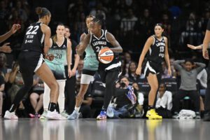 Las Vegas Aces guard Jewell Loyd dribbles the ball during a 2025 WNBA game against the New York Liberty.