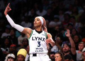 Minnesota Lynx player DiJonai Carrington celebrates a three-point shot during a 2025 WNBA game.