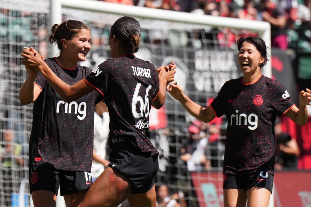 Portland Thorns attacker Pietra Tordin celebrates her goal with teammates Reilyn Turner and Hina Sugita during a 2025 NWSL match.