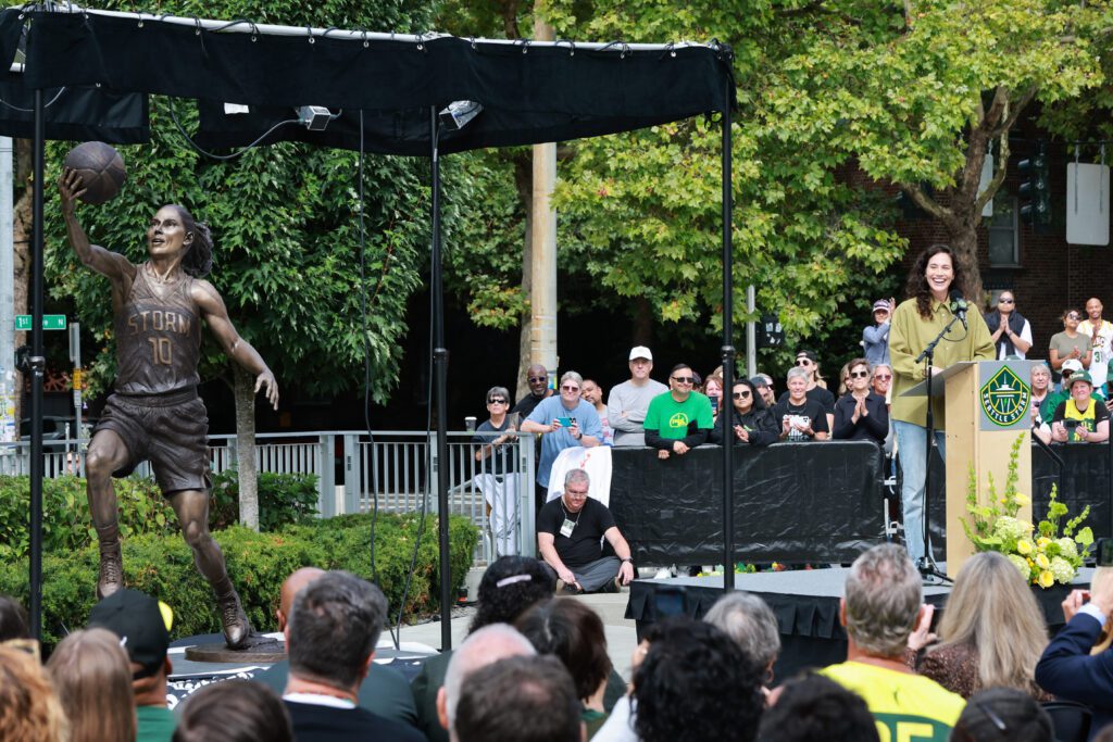 Retired Seattle Storm star Sue Bird speaks to the crowd at her 2025 statue unveiling.