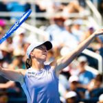 Iga Świątek tosses a serve during her 2025 Cincinnati Open semifinal against Elena Rybakina.