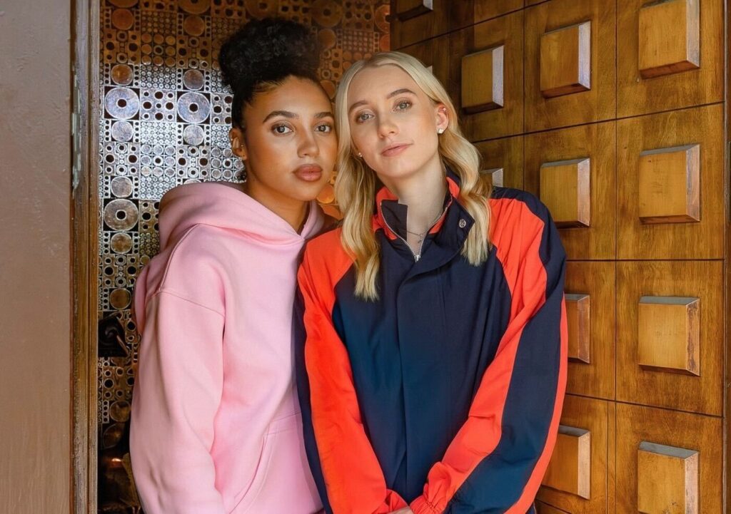 Close Friends Only Instagram podcast hosts Azzi Fudd and Paige Bueckers pose in the doorway of a house.