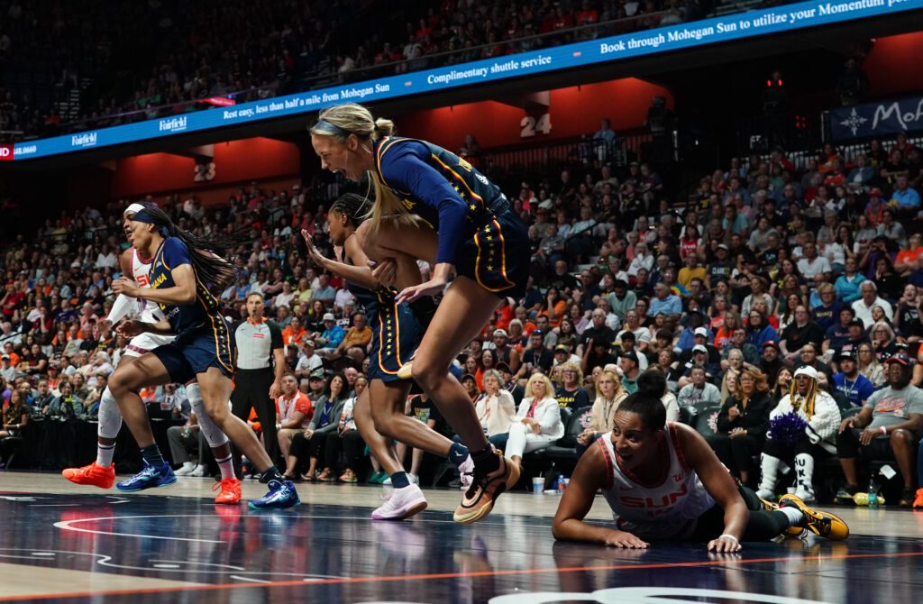 Indiana Fever guard Sophie Cunningham clutches her knee after being injured during a 2025 WNBA game.