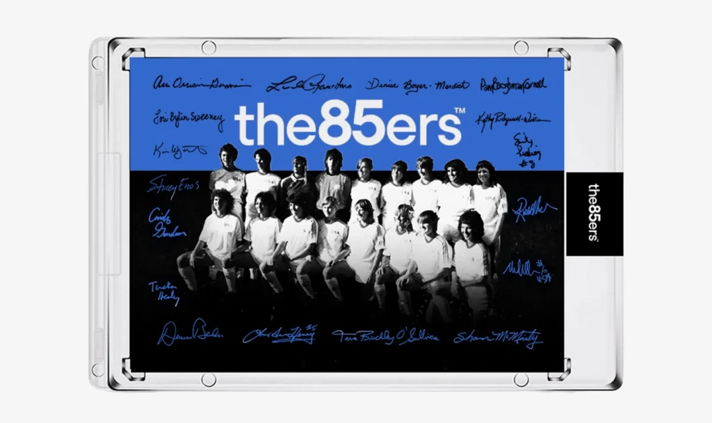 A limited-edition commemorative trading card features the inaugural 1985 USWNT team with facsimile player signatures.