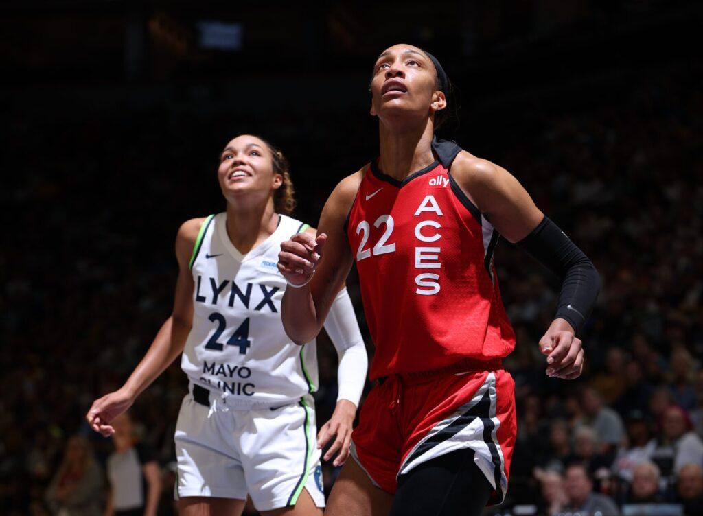 Las Vegas Aces center A'ja Wilson and Minnesota Lynx star Napheesa Collier look up during a 2024 WNBA game.